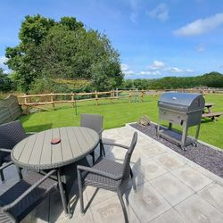 BBQ and set of table and chairs in Cothi Cottage Garden
