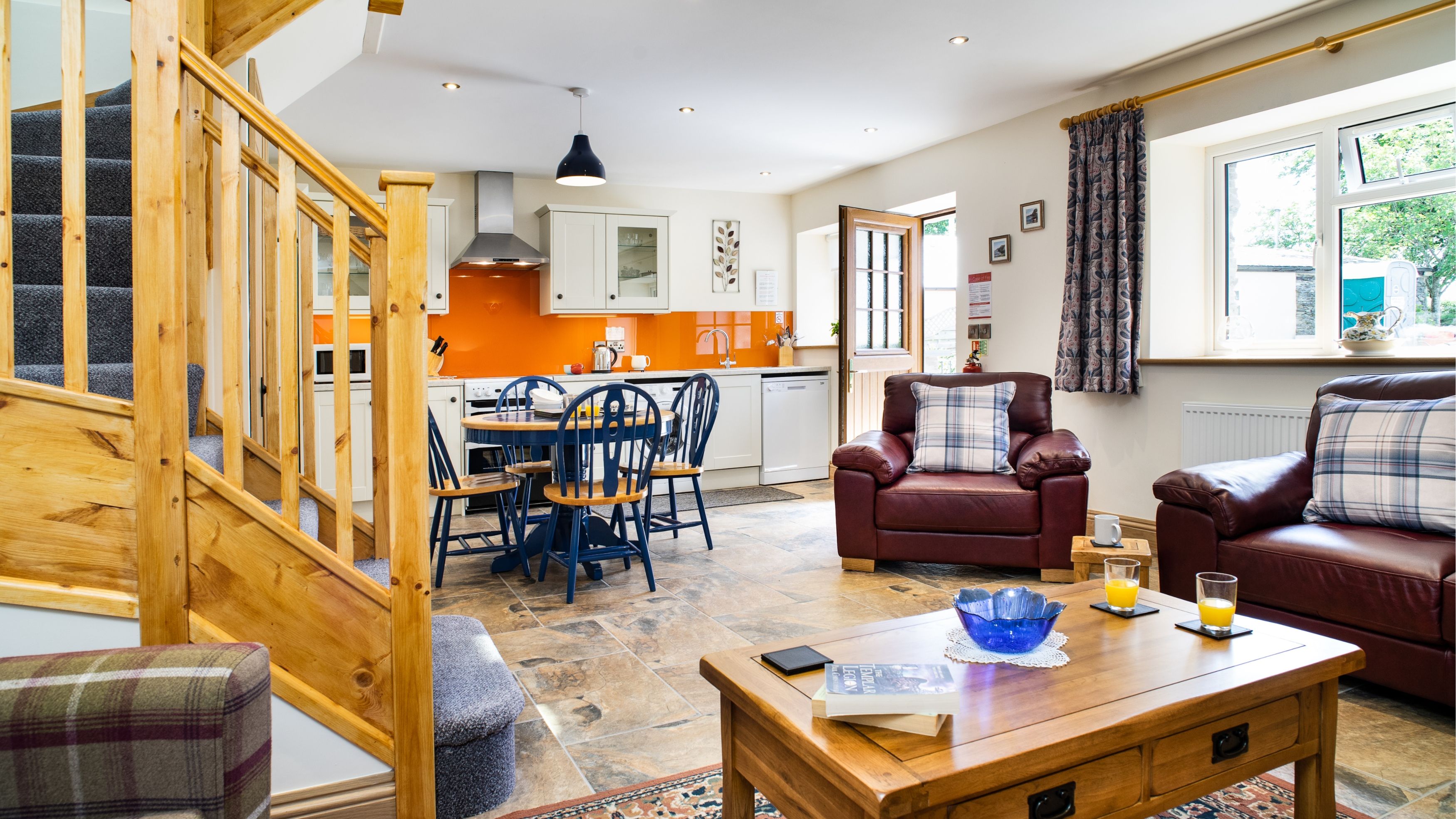 Living space with leather sofas and spacious kitchen