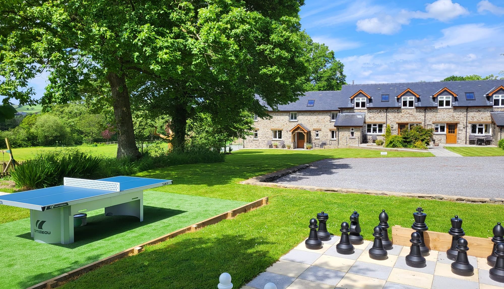 Large garden chess set and table tennis table in the garden at Penwern Farm Cottages