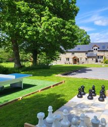 Outdoor communal area with table tennis and giant chess with a view across to the cottages
