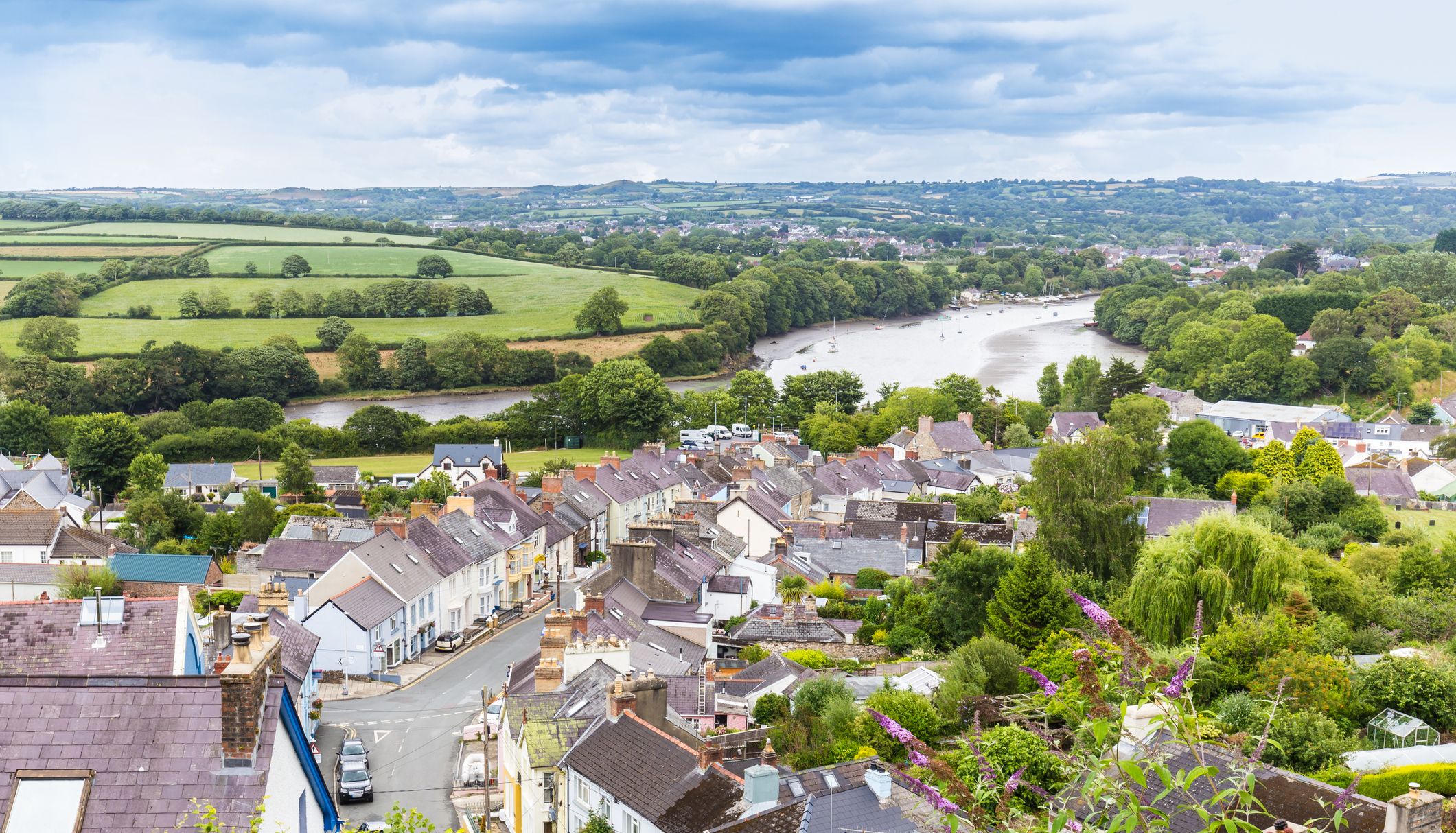a view over the town of cardigan and a view along the river teifi