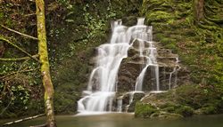 Waterfall with quick flowing water along the rocks