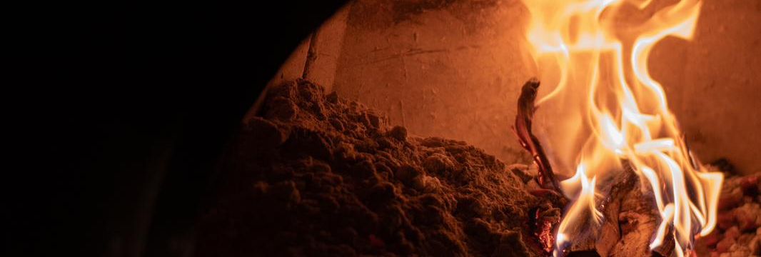Wood fire burning inside a stone oven