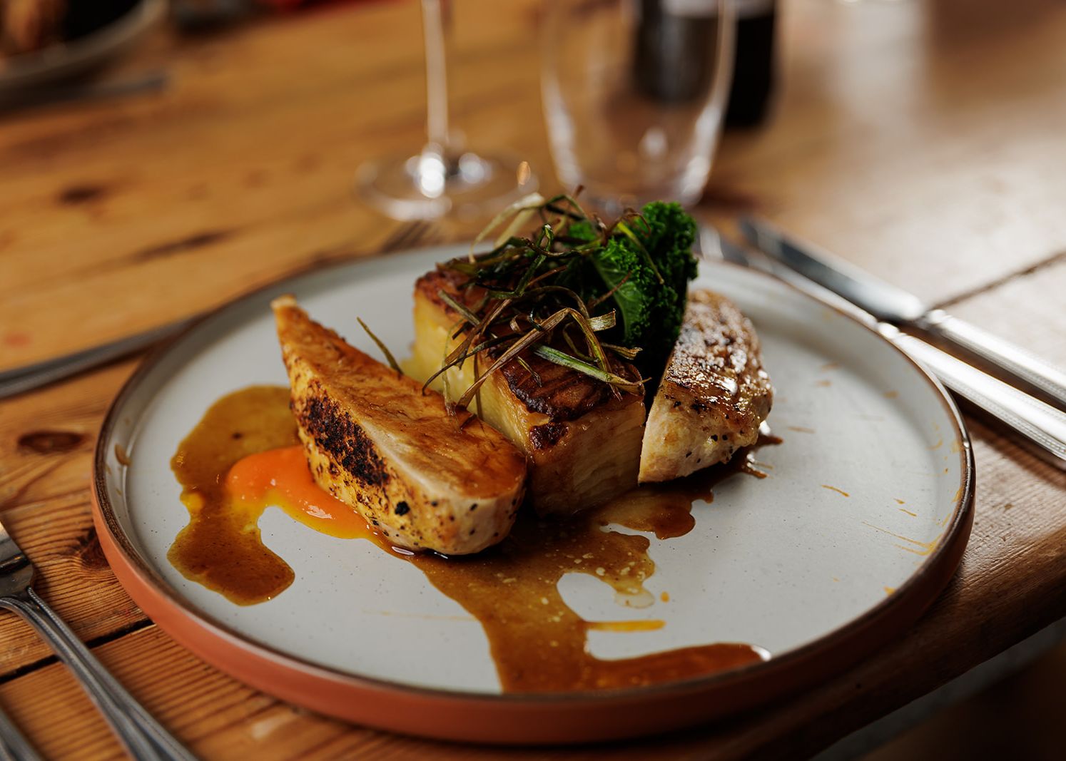 Gourmet chicken dish with vegetables and sauce on a plate