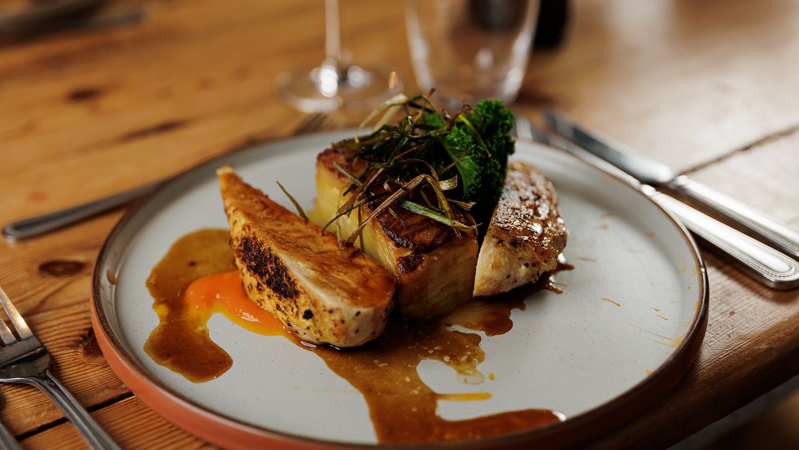 Gourmet chicken dish with vegetables and sauce on a plate