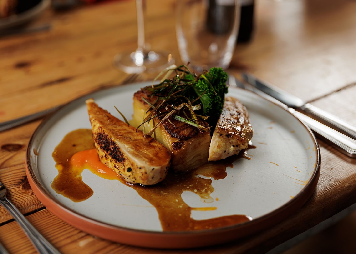 Gourmet chicken dish with vegetables and sauce on a plate