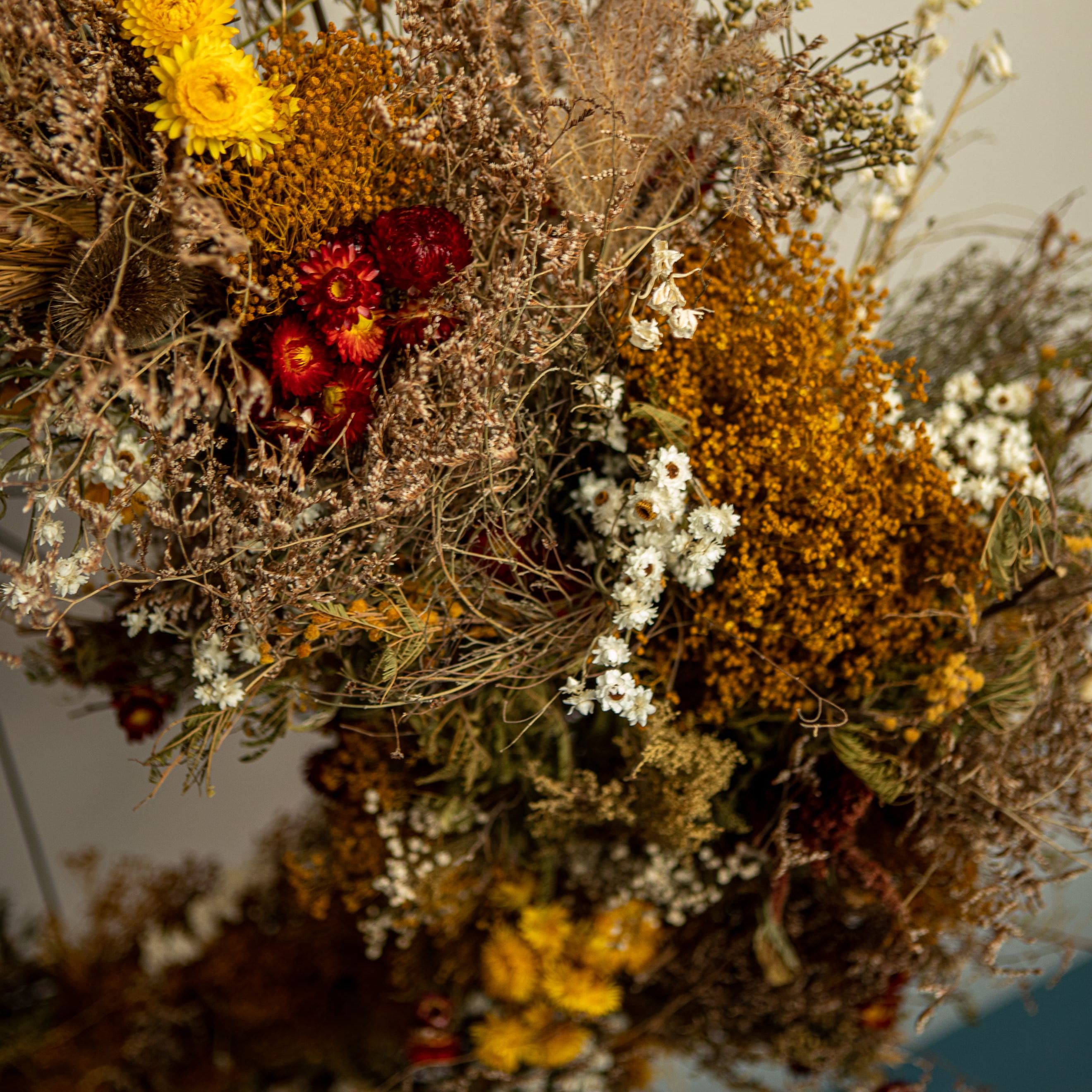Colorful dried flower arrangement with yellow, red, and white flowers