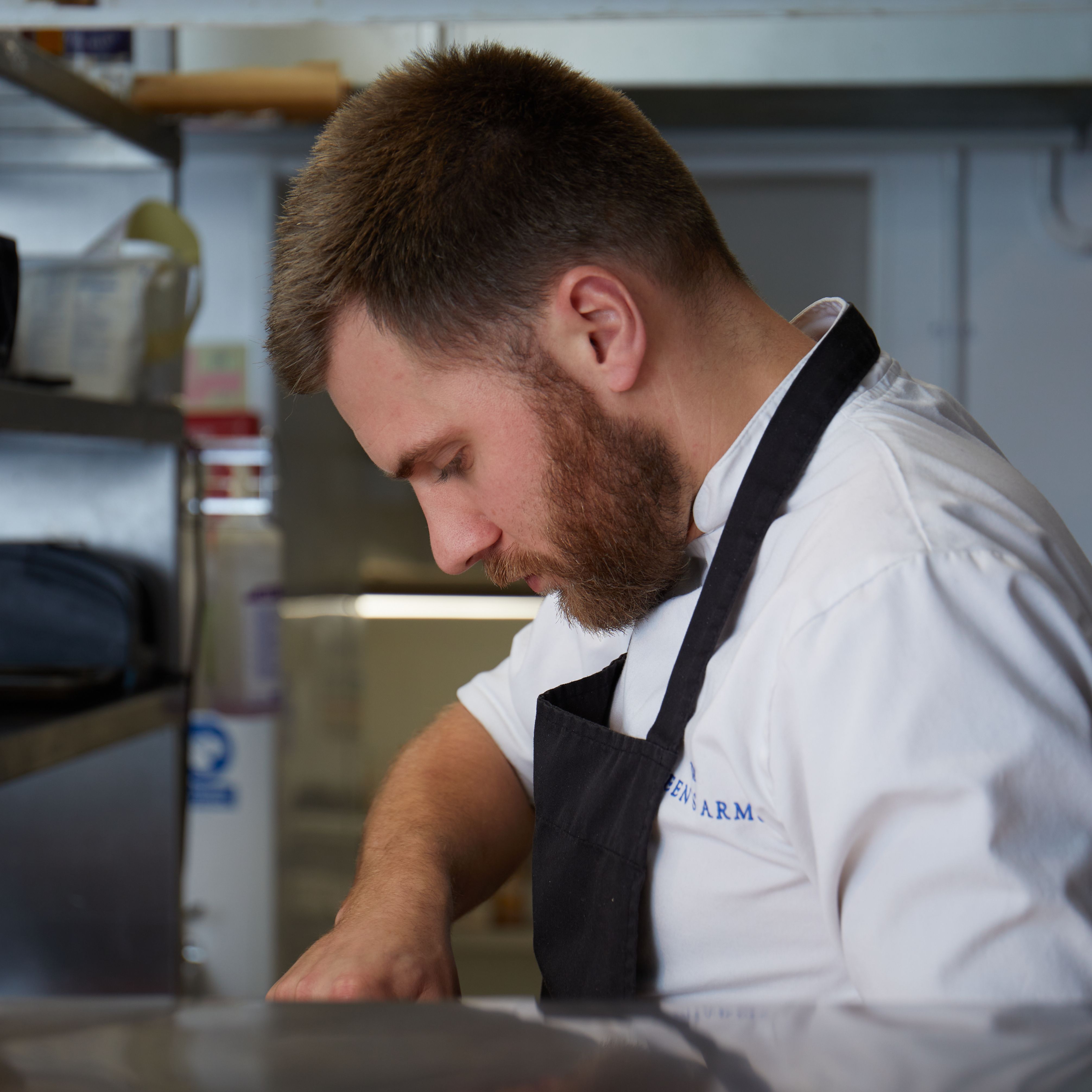 Chef focused on preparing food in a professional kitchen