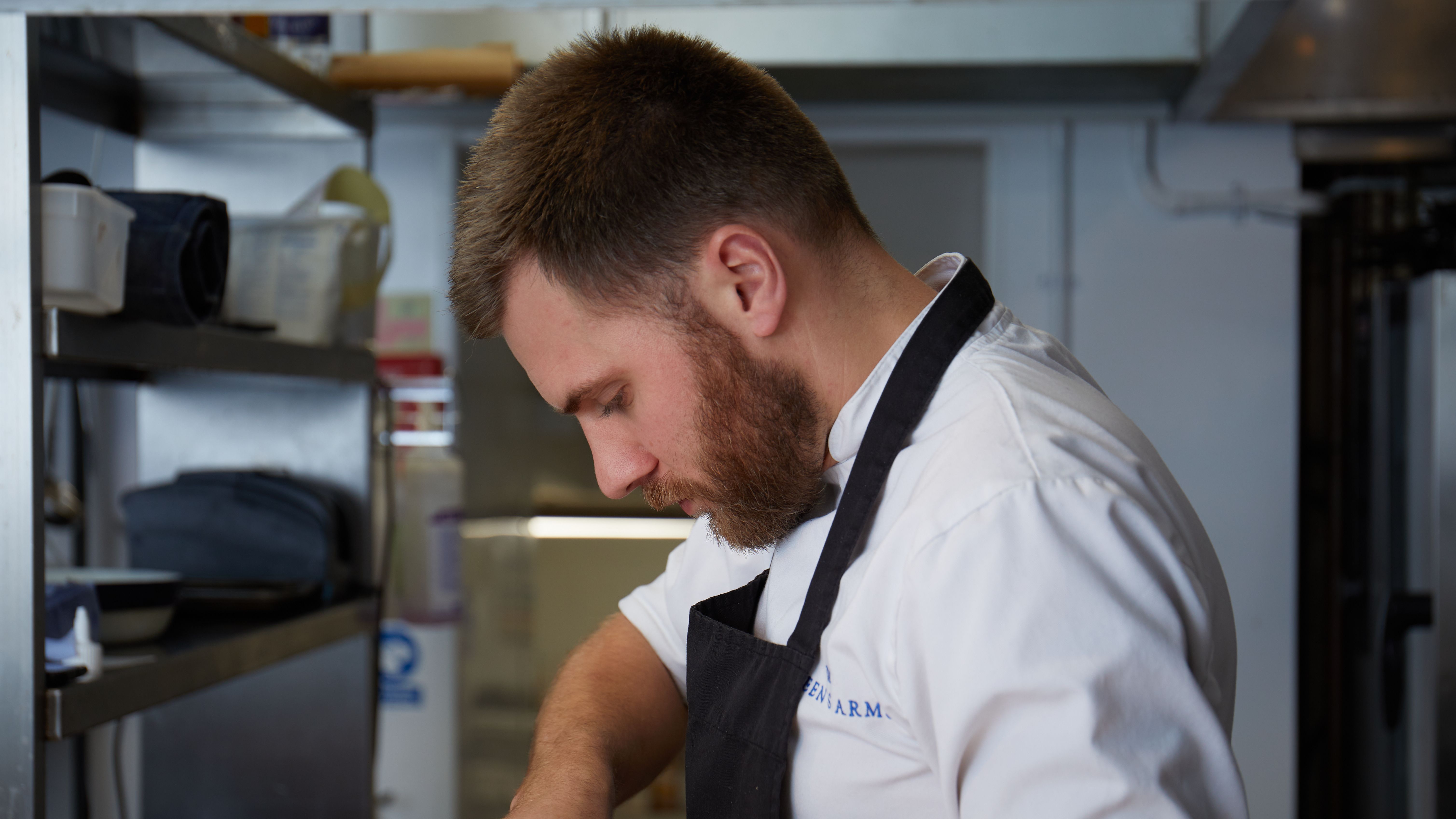 Chef focused on preparing food in a professional kitchen