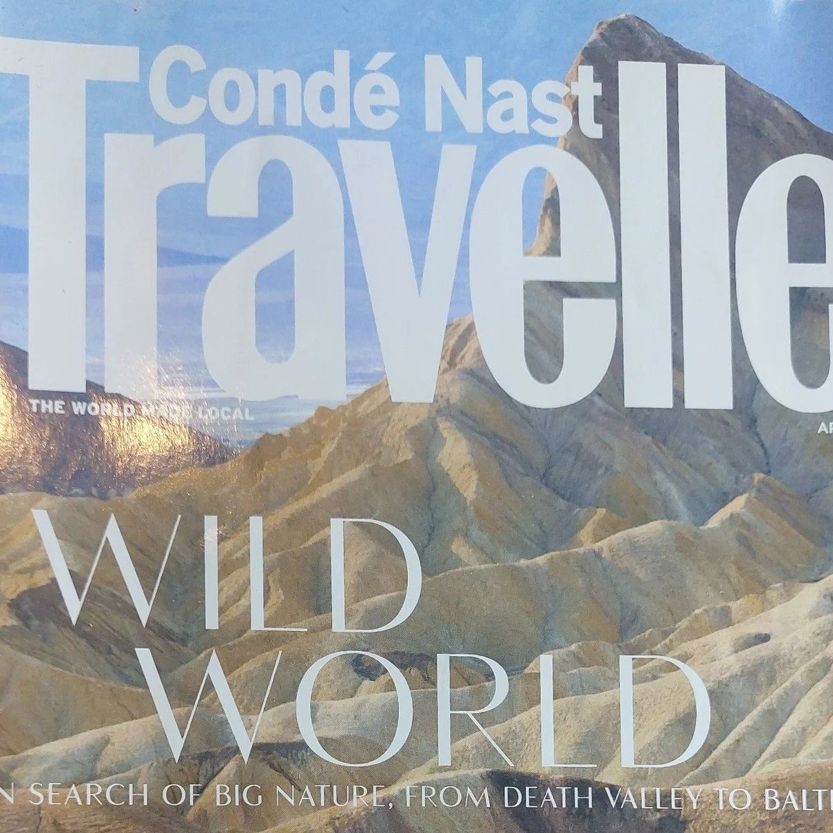 Cover of Condé Nast Traveller magazine, April 2023 issue, featuring a mountainous landscape and the headline 'Wild World'