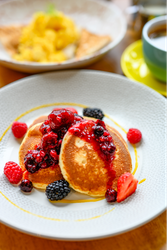 Pancakes with berries and maple syrup