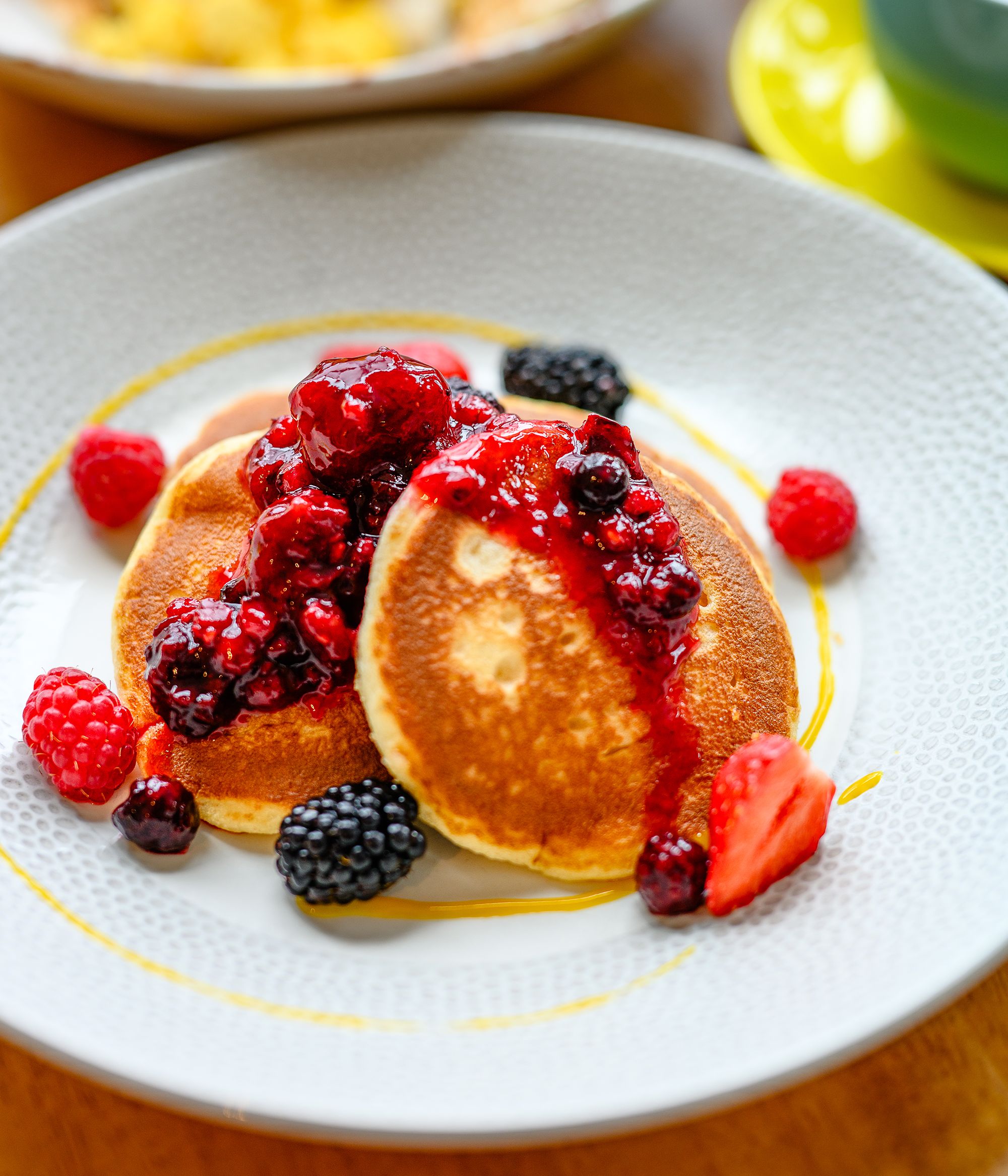 Pancakes with berries and maple syrup