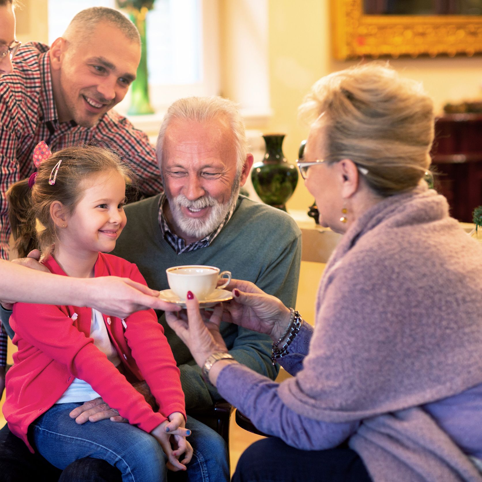 Family with young girl drinking a hot chocolate