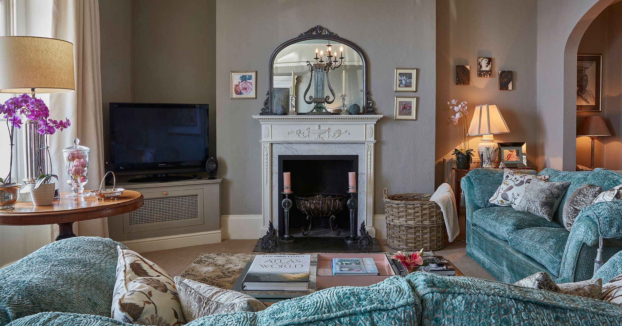 Living room with blue sofa, facing a fireplace