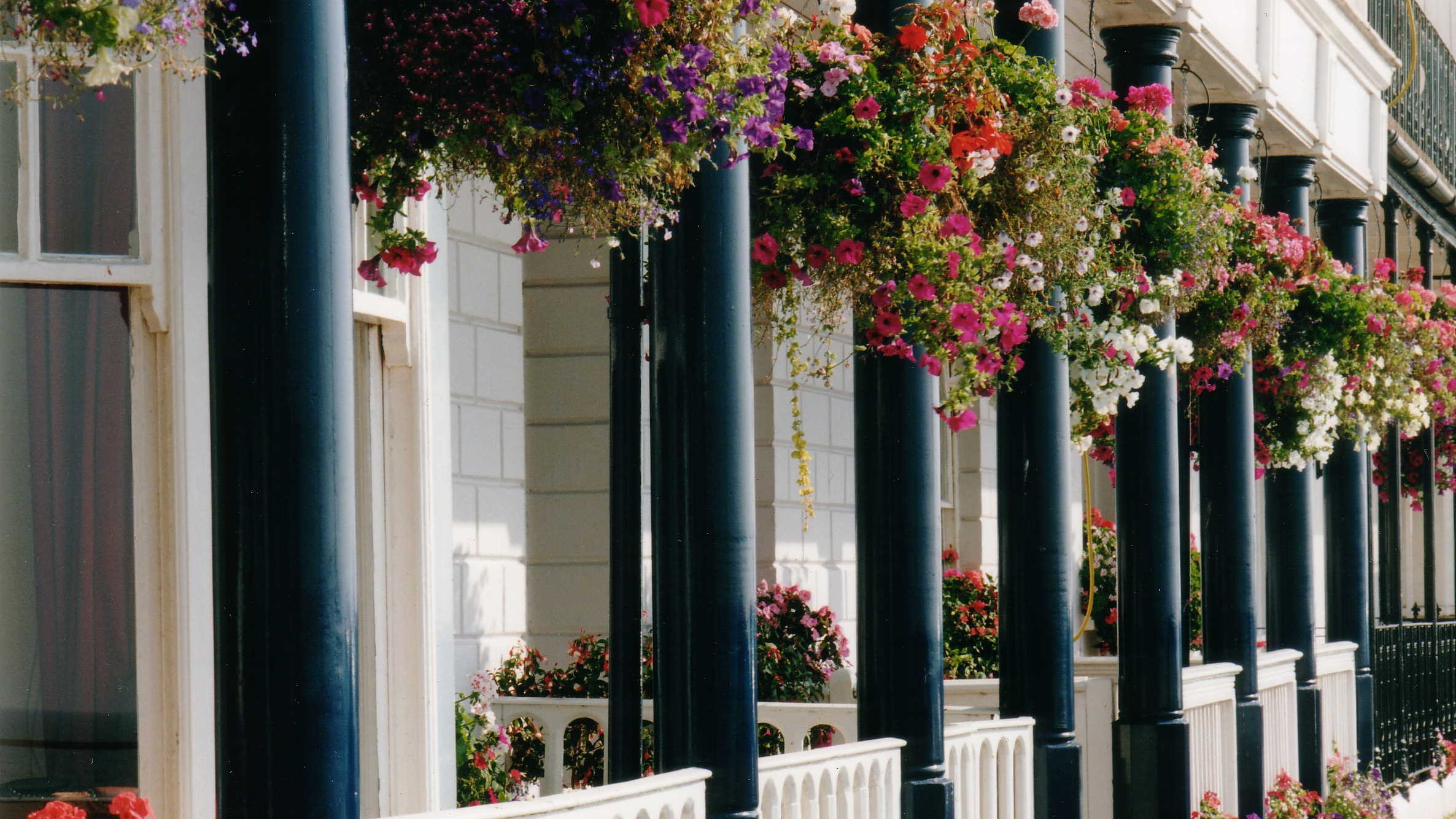 Shop front with white fence and black pillars
