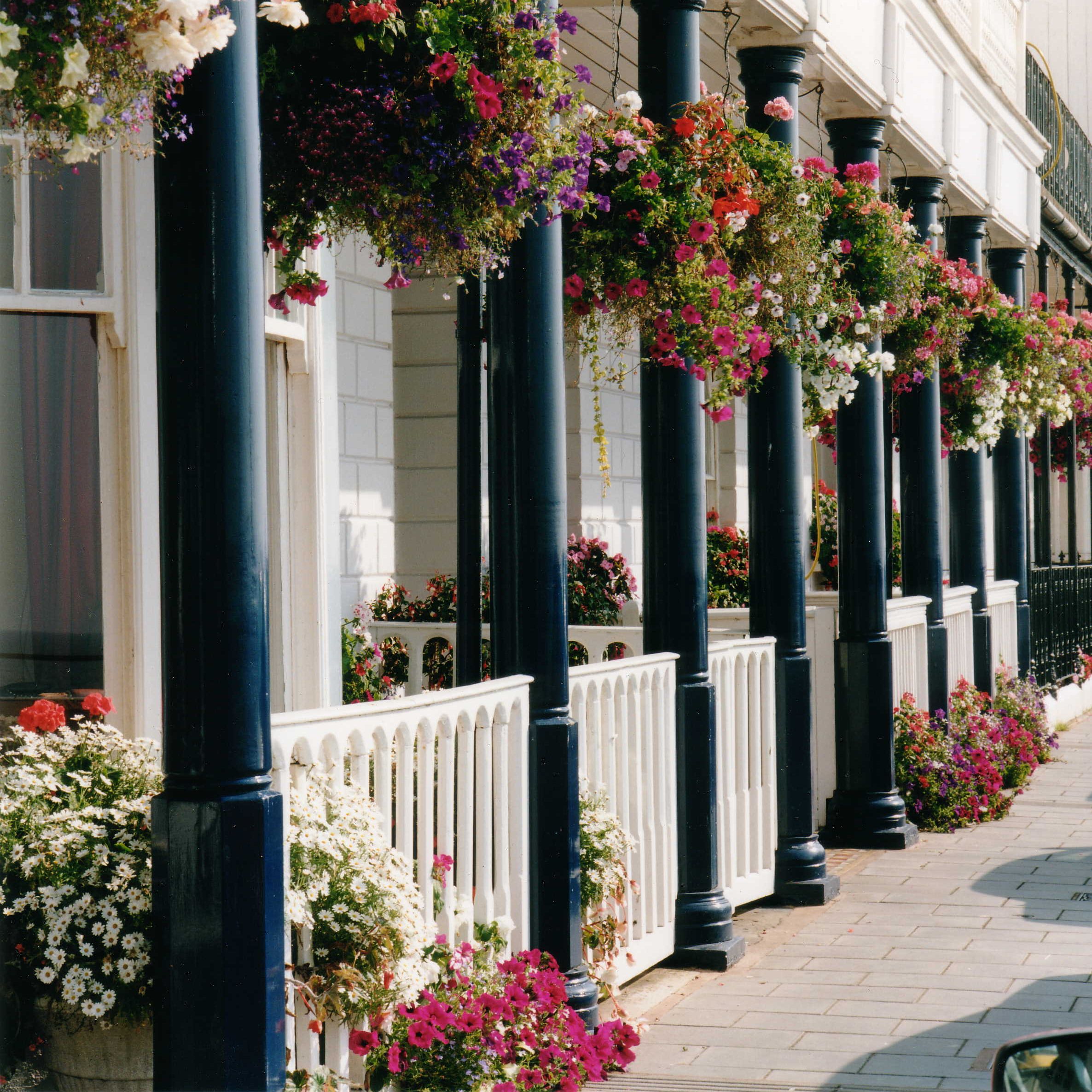 Shop front with white fence and black pillars