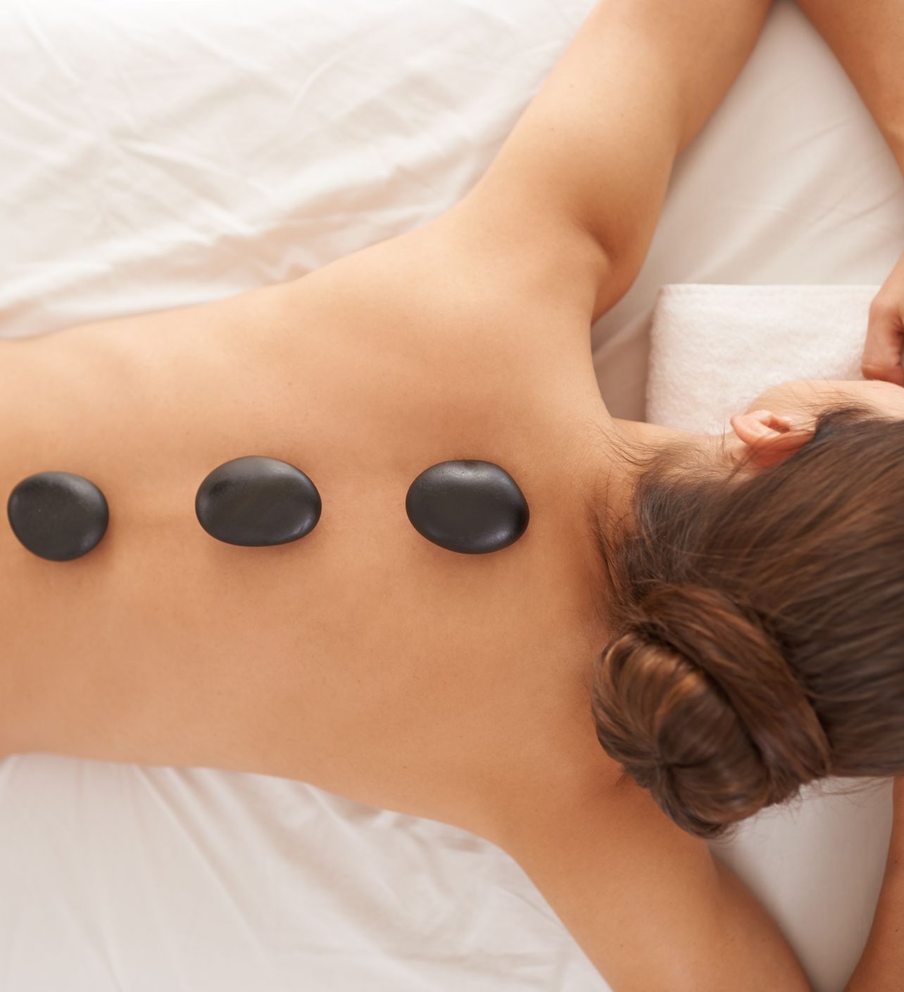 Lady Having Hot Stone Spa Treatment