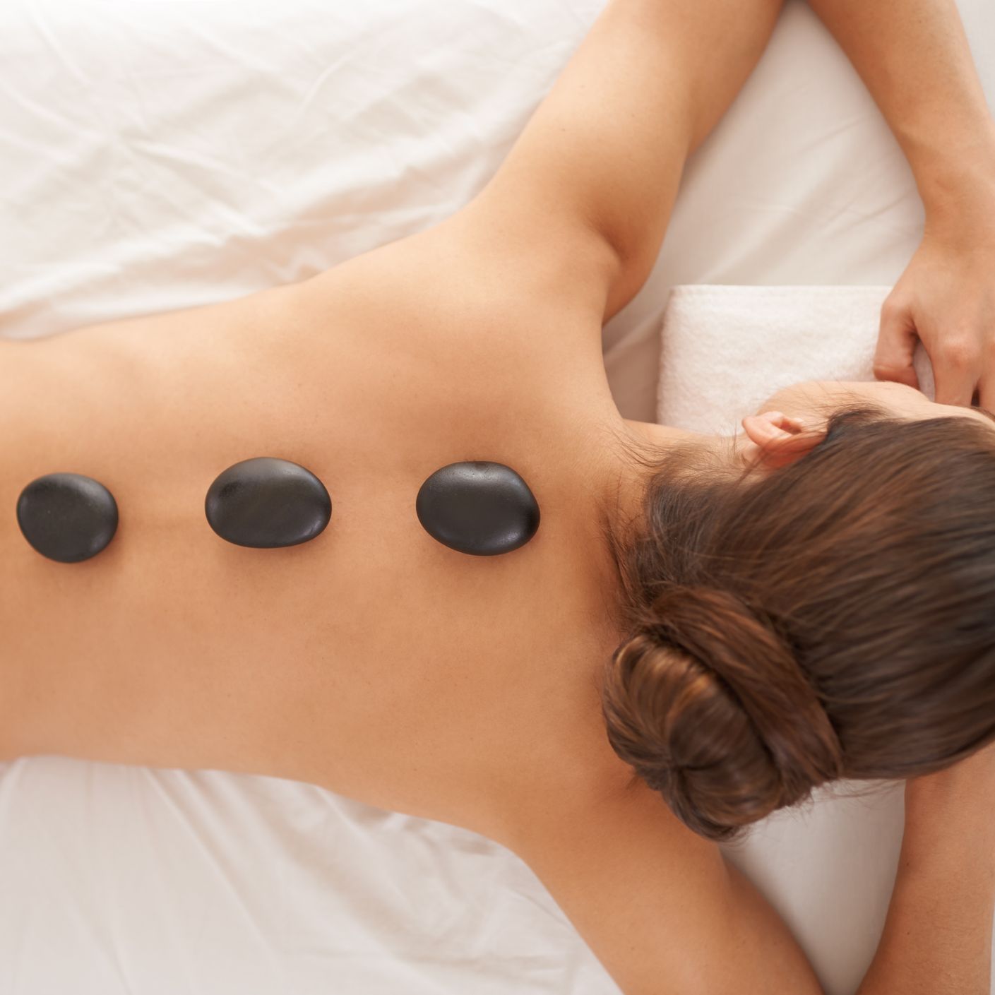 Lady Having Hot Stone Spa Treatment