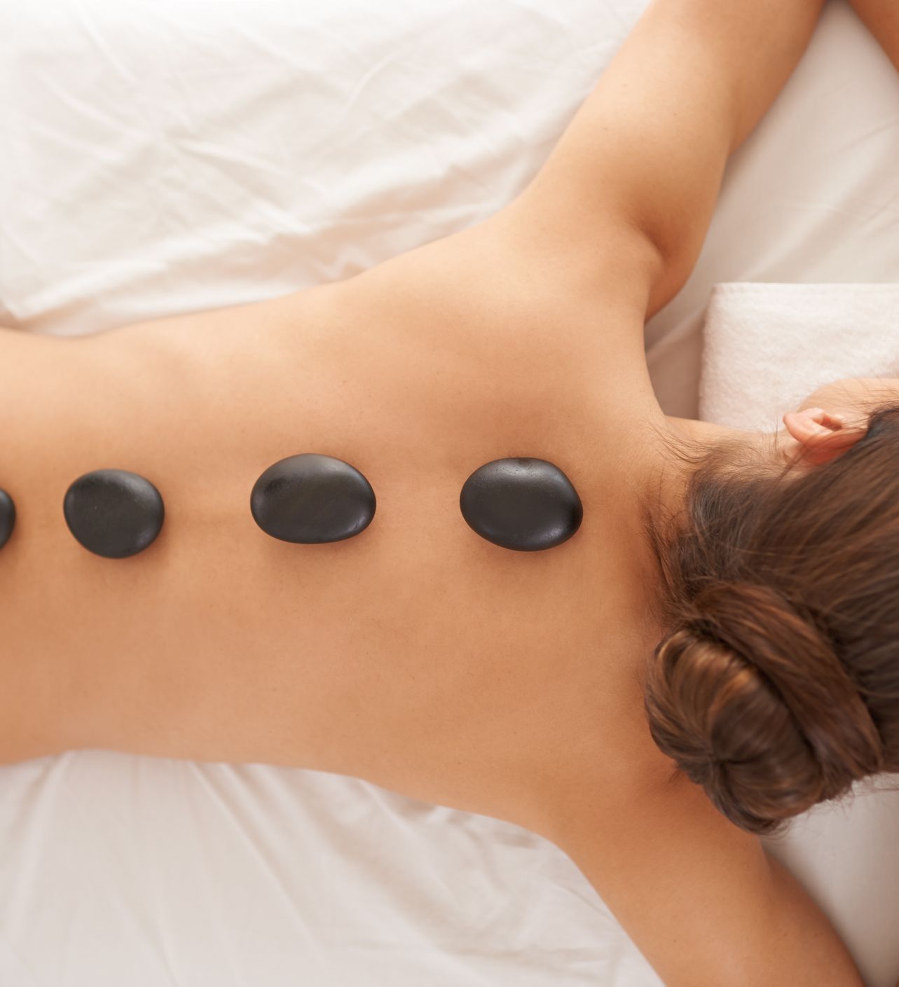 Lady Having Hot Stone Spa Treatment