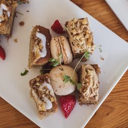 Assorted pastries and macarons on a white plate