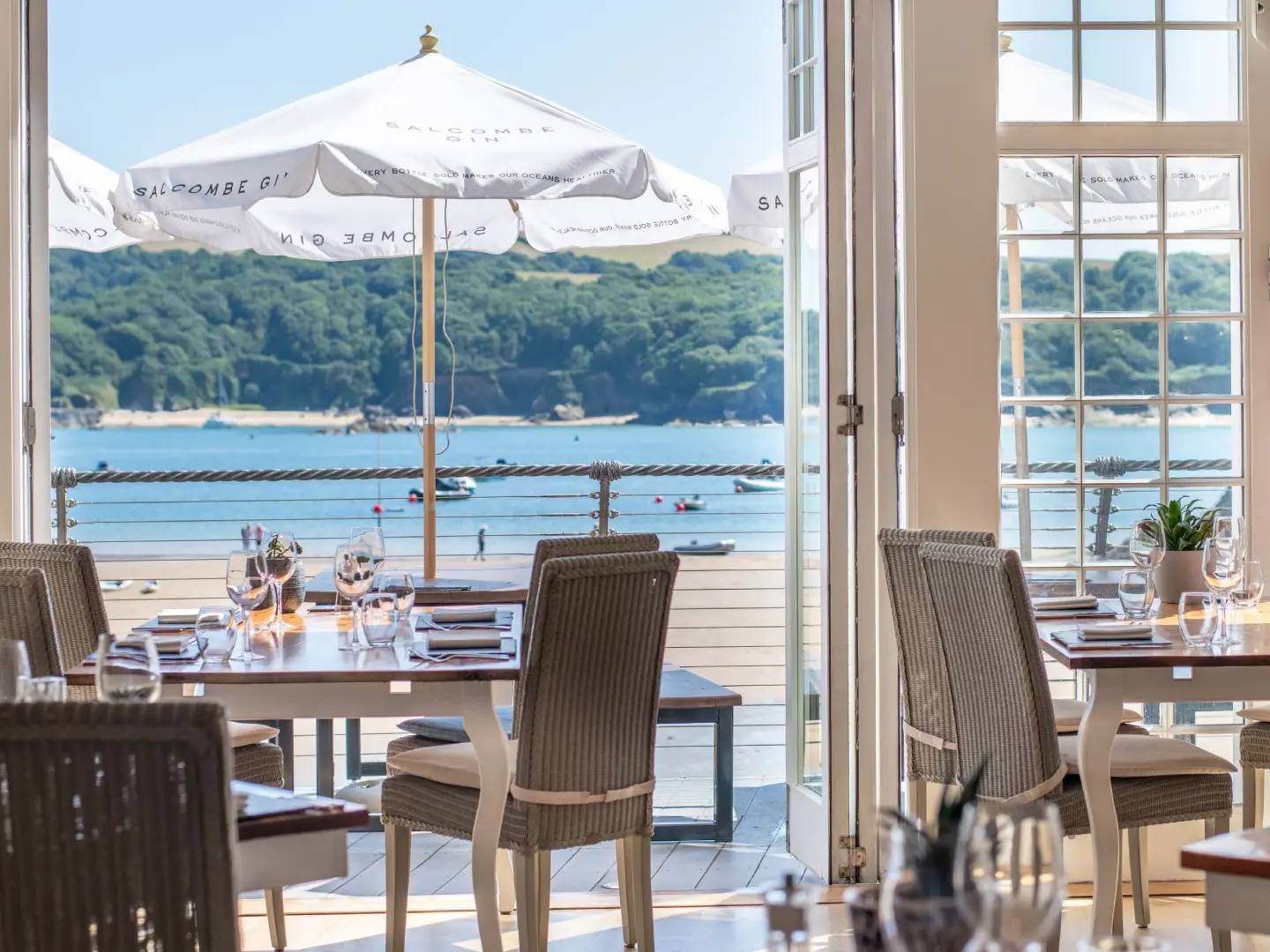 Restaurant interior with sea view and outdoor umbrellas