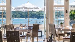 Restaurant interior with sea view and outdoor umbrellas
