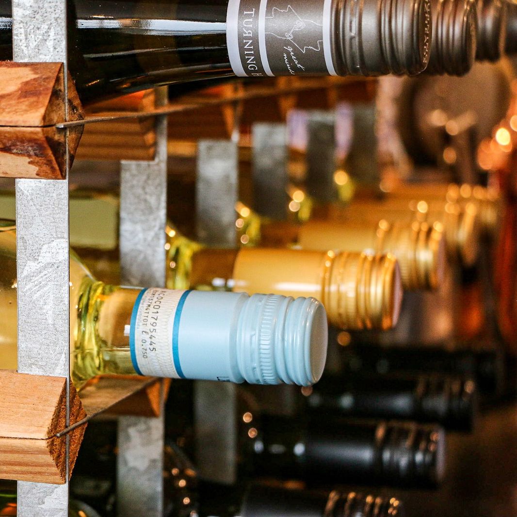 Close-up of bottles of wine stored in a wooden wine rack