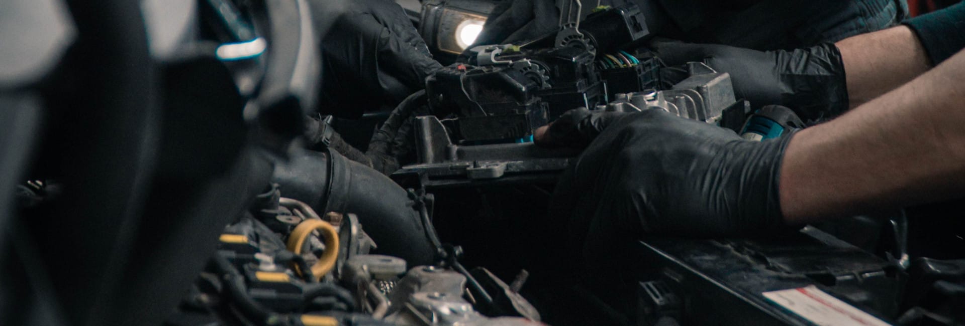 Mechanic In Bonnet of Car