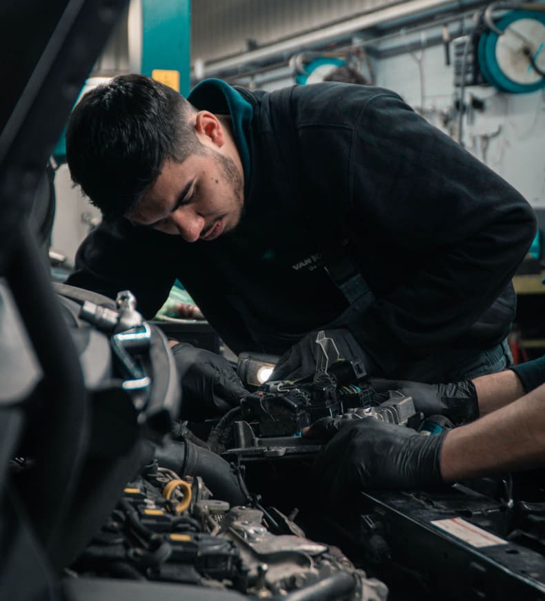Mechanic In Bonnet of Car