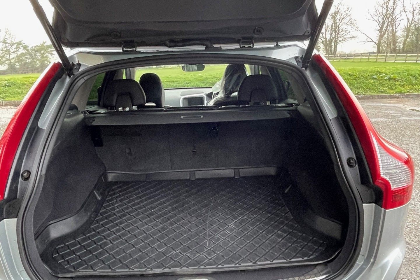 Open trunk of a Volvo XC60 SUV showing the spacious cargo area with a rubber mat.
