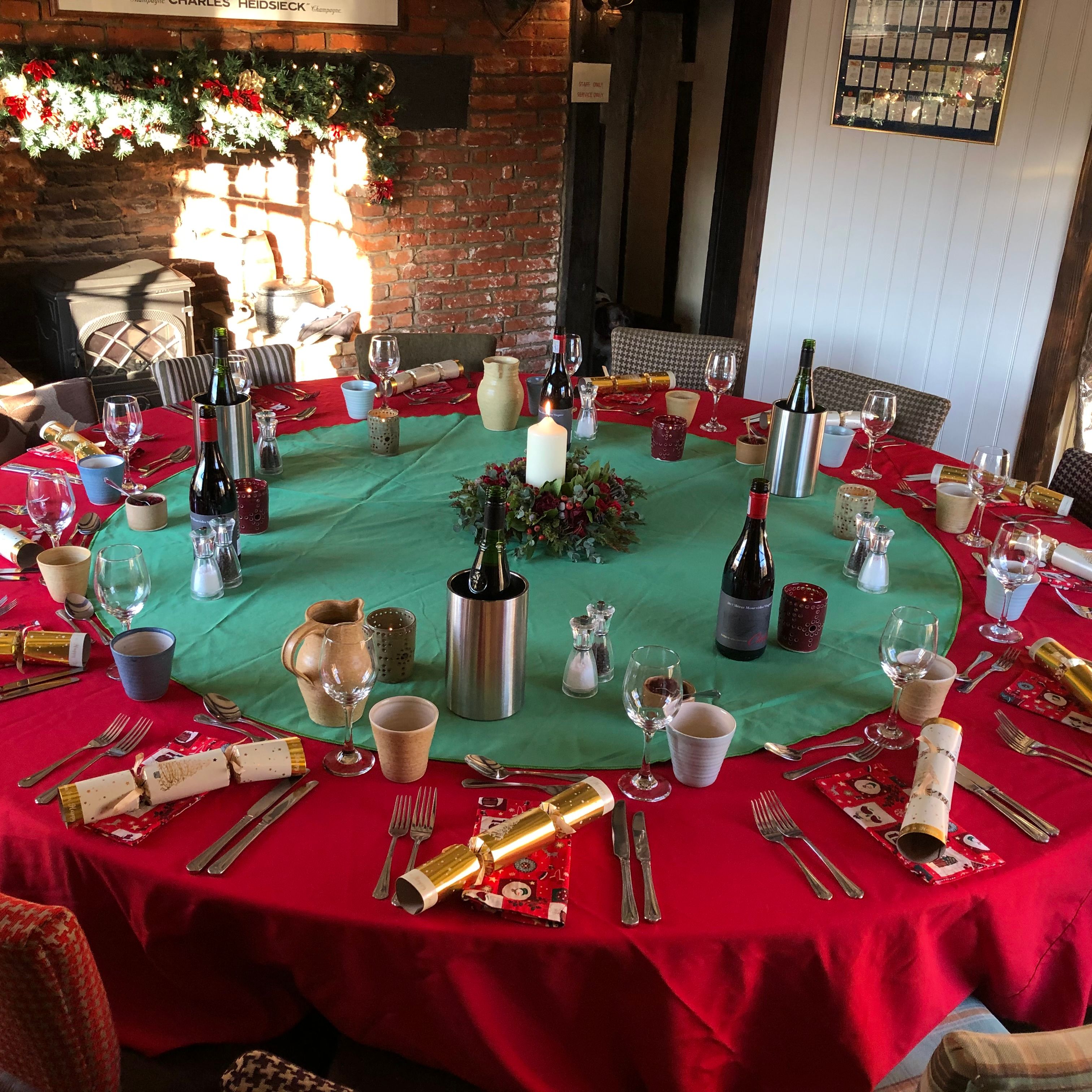 Festively decorated round dining table set for Christmas celebration