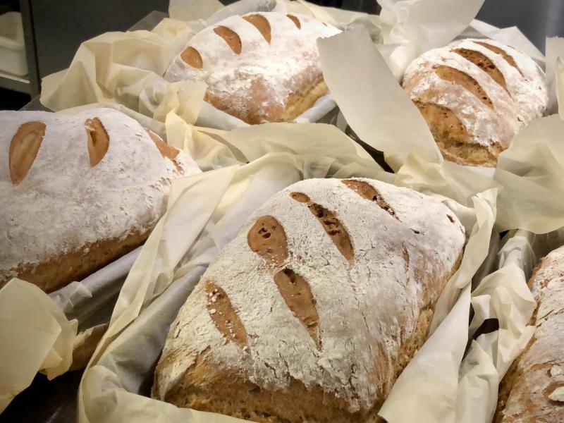 Loaves of freshly baked bread in parchment paper