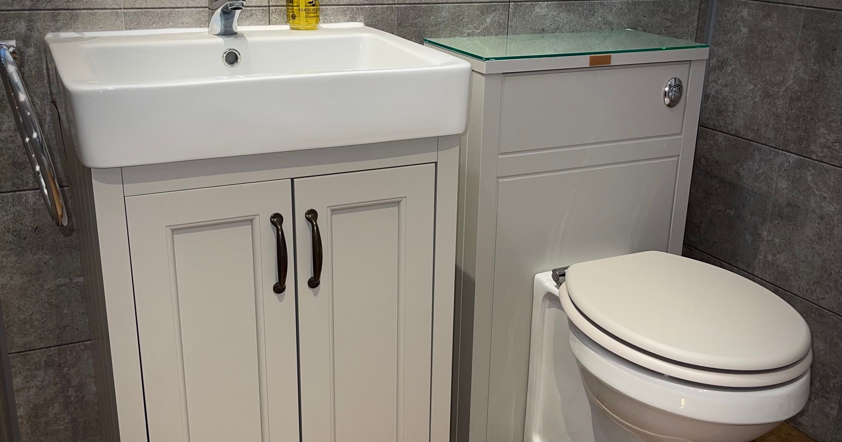 Modern bathroom with white sink vanity unit and toilet