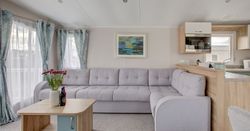 Lounge Area with large grey sofa next to window