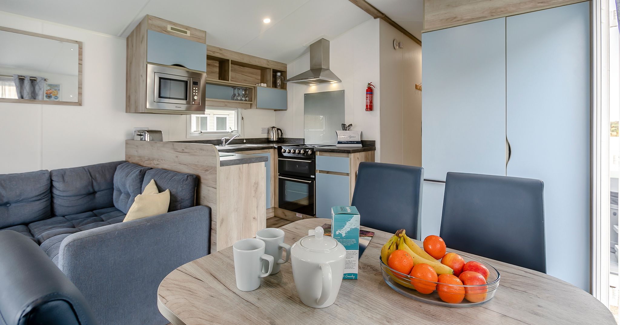 Modern kitchen and dining area with fruit bowl and tea set on table