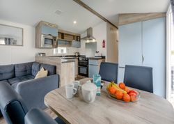 Modern kitchen and dining area with fruit bowl and tea set on table