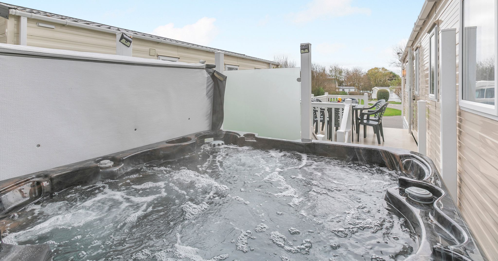 Outdoor hot tub and patio at a mobile home park