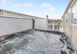 Outdoor hot tub and patio at a mobile home park