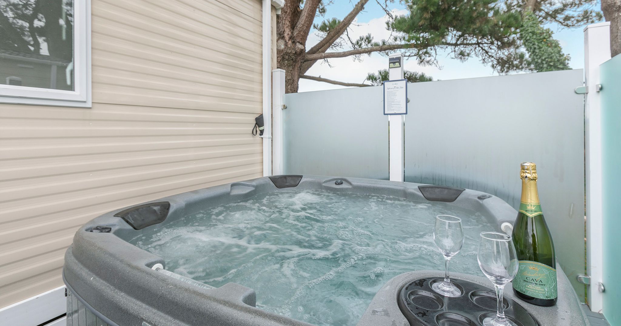 Outdoor hot tub with champagne and glasses