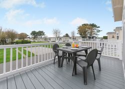 Outdoor deck with table and chairs at a holiday park with mobile homes