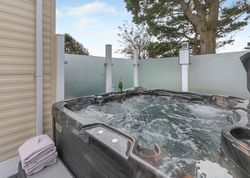 Outdoor hot tub with bubbling water, champagne bottle, and glasses
