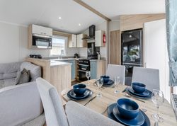 Modern open-plan kitchen and dining area inside a cozy home.