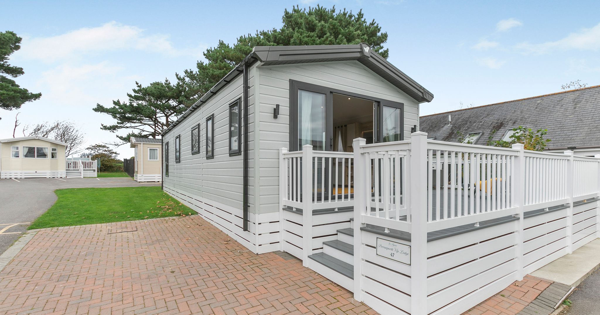 Modern holiday park static caravan with white deck and railing