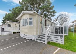 Modern mobile home with deck and parking space in a holiday park