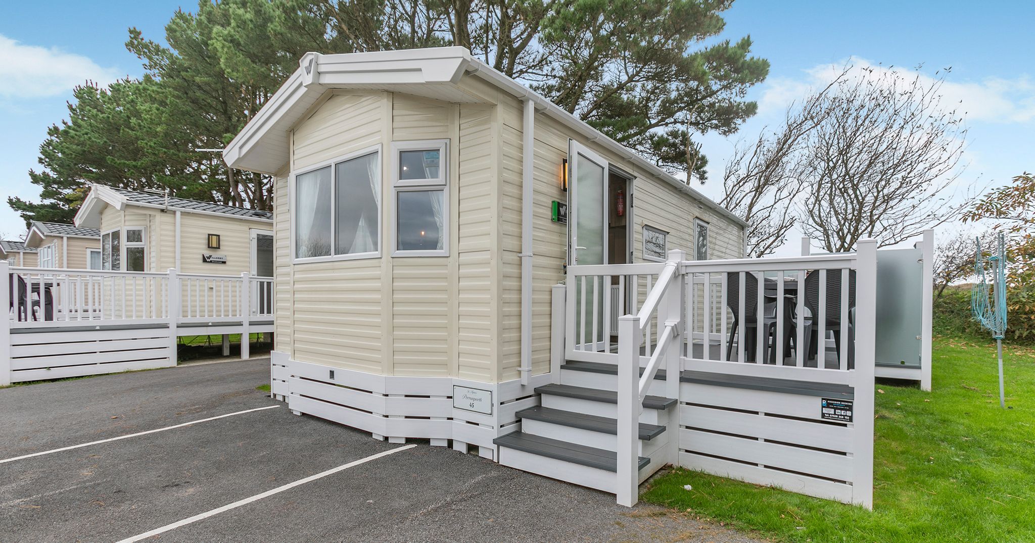 Modern mobile home with deck and parking space in a holiday park