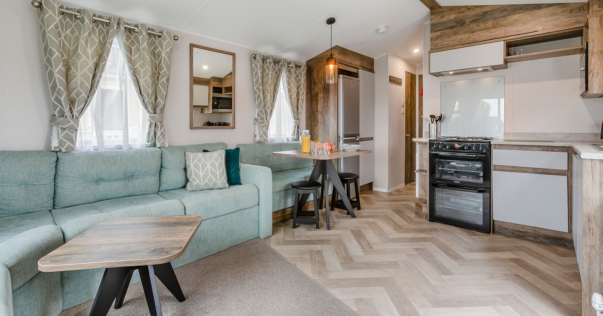 Modern open-plan living area and kitchen in a mobile home or holiday lodge