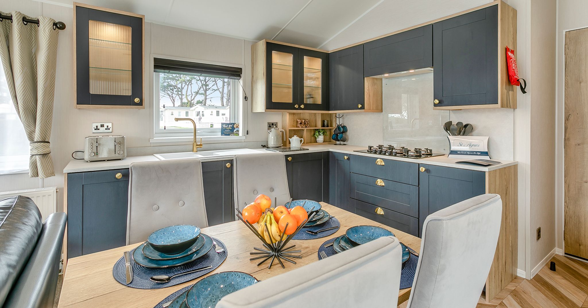 Modern kitchen and dining area with navy cabinets and a set dining table