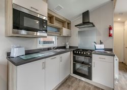 Modern kitchen with microwave, stove, and appliances