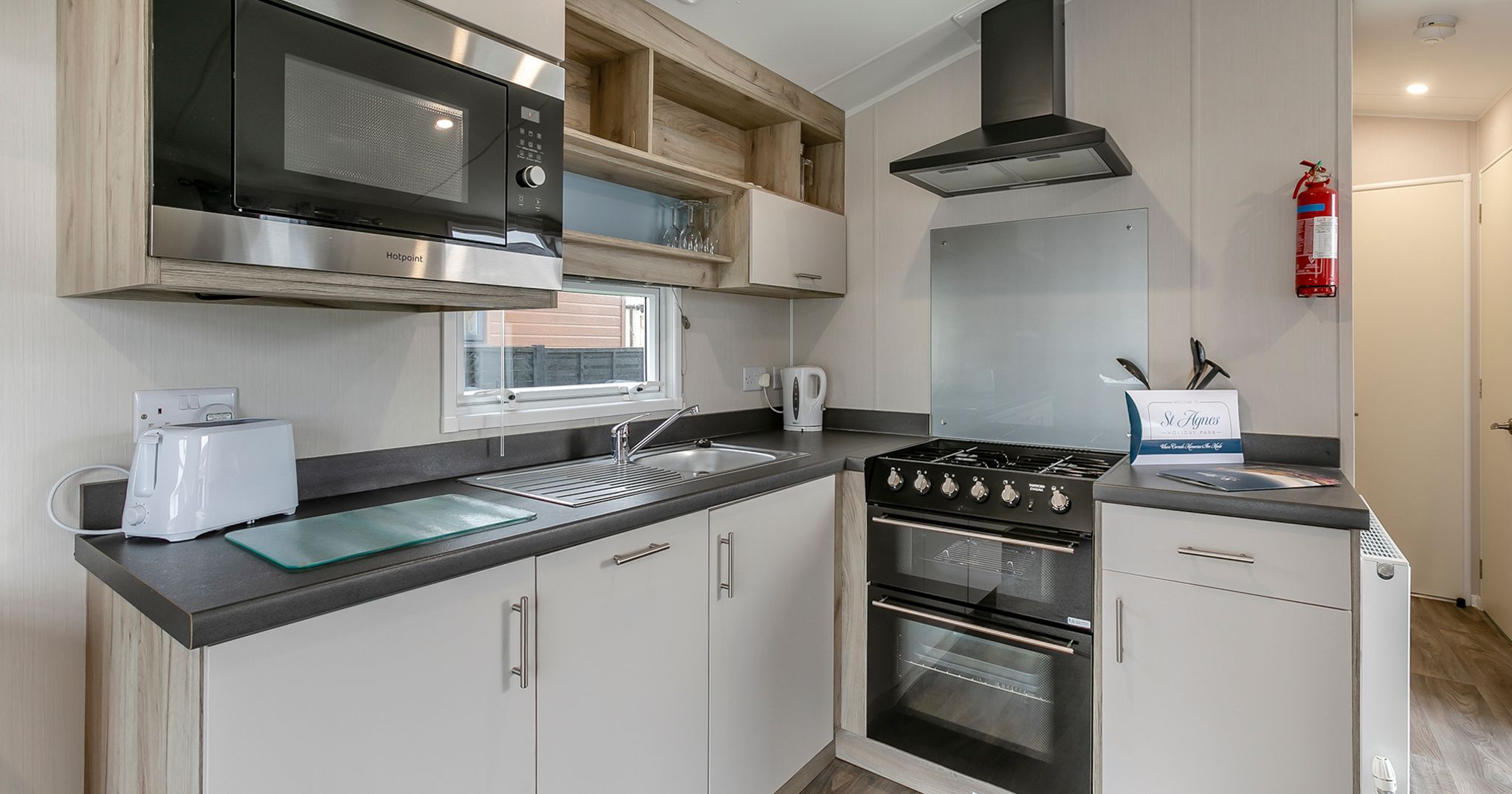 Modern kitchen with microwave, stove, and appliances