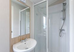 Modern bathroom with glass shower and white sink